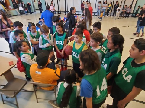 Coed basketball team huddle.