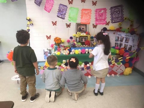 Children viewing Day of the Dead altar